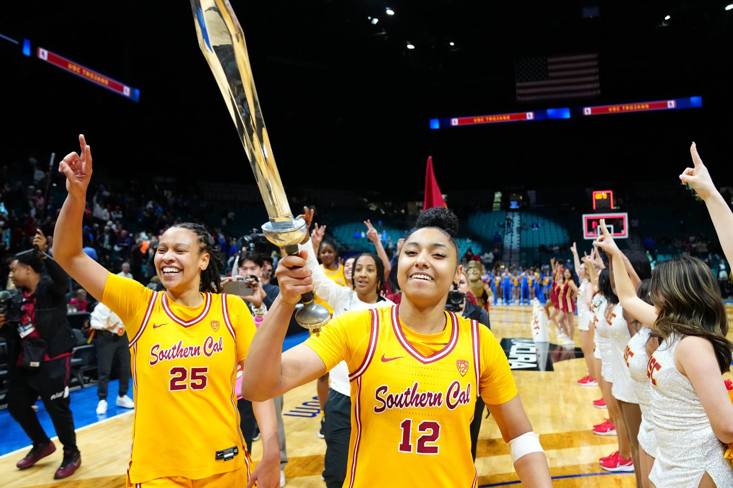 Mar 8, 2024; Las Vegas, NV, USA; USC Trojans guard JuJu Watkins (12) celebrates with USC Trojans guard McKenzie Forbes (25) after the Trojans defeated the UCLA Bruins 80-70 in double overtime at MGM Grand Garden Arena. 